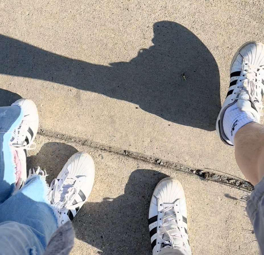 close up of adidas superstars on richard and amy as they are walking in DC